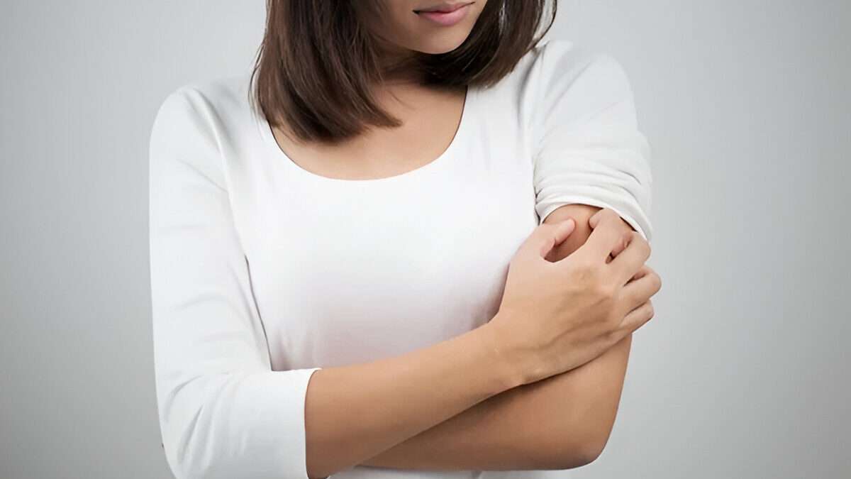 A Girl itching is hand who has Skin Allergy